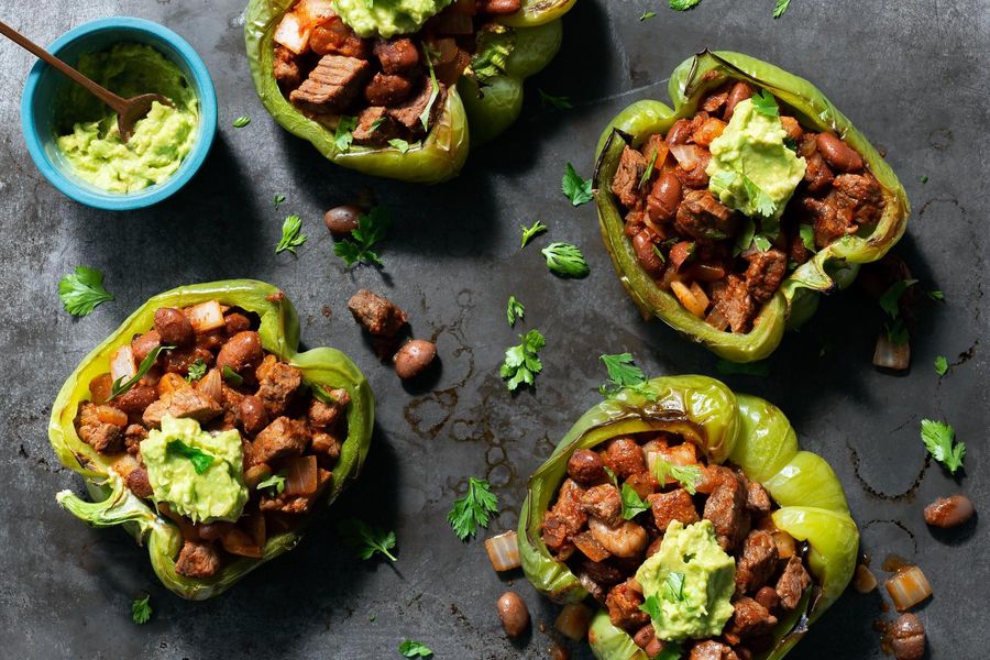 Steak-stuffed peppers with pinto beans and guacamole