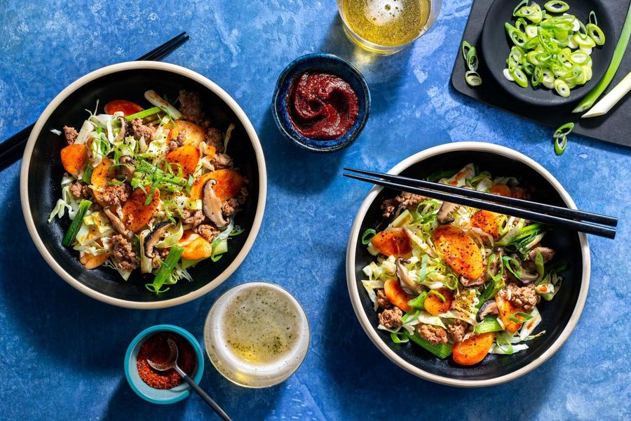 Korean tteokbokki rice cake stir-fry with pork and shiitake mushrooms