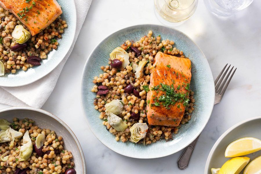 Salmon with lemon-oregano sauce and artichoke-fregola pilaf