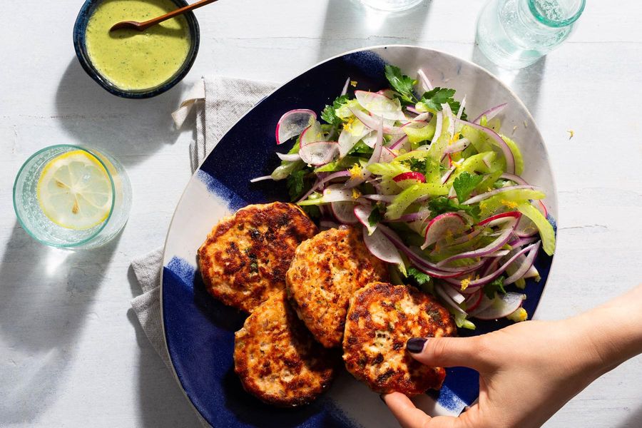 Salmon cakes with tahini goddess dressing and celery-radish salad