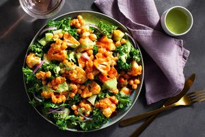 Buffalo cauliflower and chickpeas over kale-cucumber salad