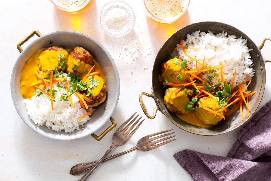 Zucchini and potato kofta curry with baby greens over basmati rice