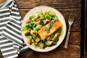 Salmon panzanella salad with crisp lettuce, salsa verde, and Parmesan