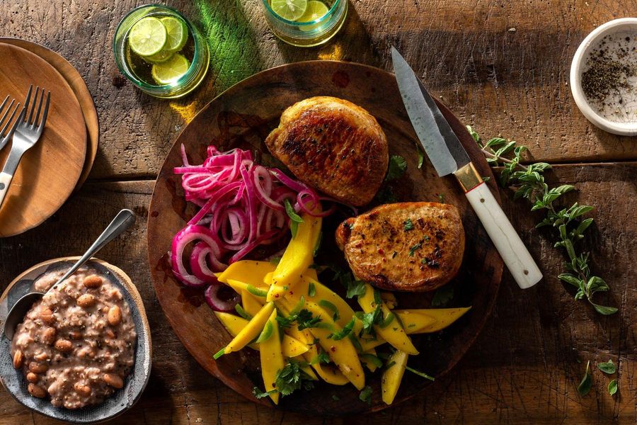 Poc chuc pork chops with refried beans and mango salad