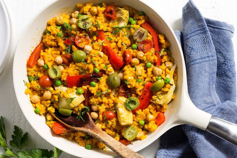 Chickpea paella with artichoke hearts, bell pepper, and tomatoes image