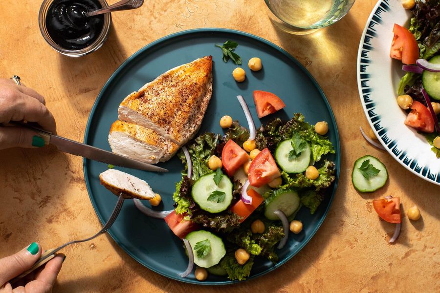 Chicken breasts with Persian Shirazi salad and black tahini dressing